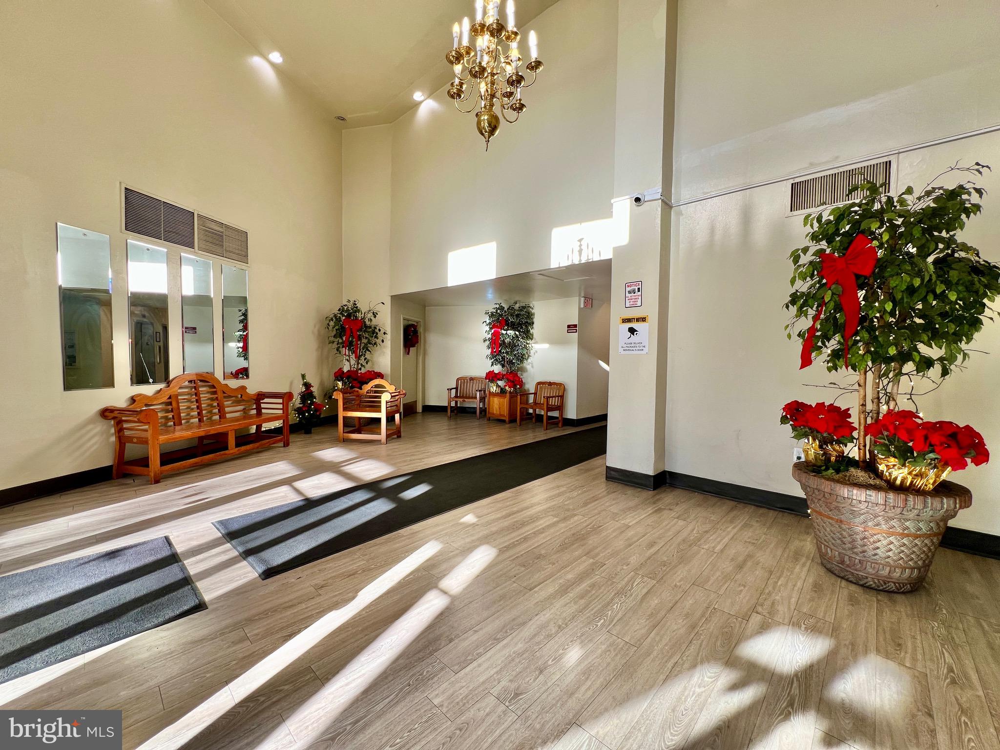 8830 Piney Branch Road, Unit 402 Silver Spring, MD 20903 - Photo 20 of 23 a living room with furniture gym equipment and a chandelier