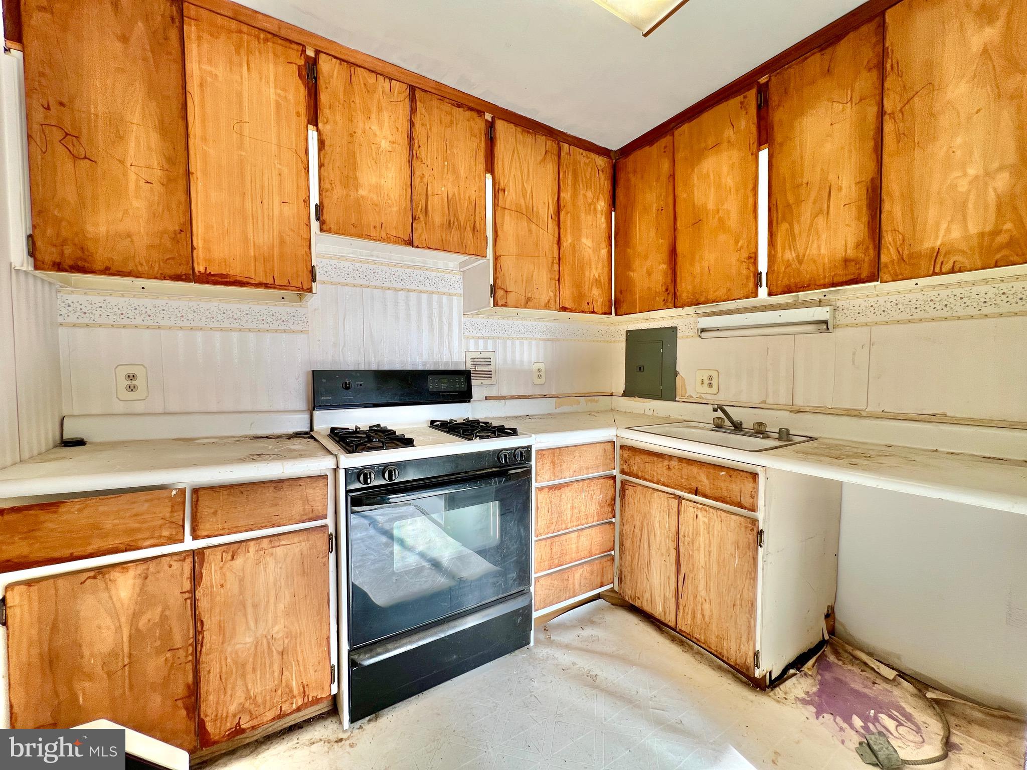 8830 Piney Branch Road, Unit 402 Silver Spring, MD 20903 - Photo 4 of 23 a kitchen with a sink stove and cabinets