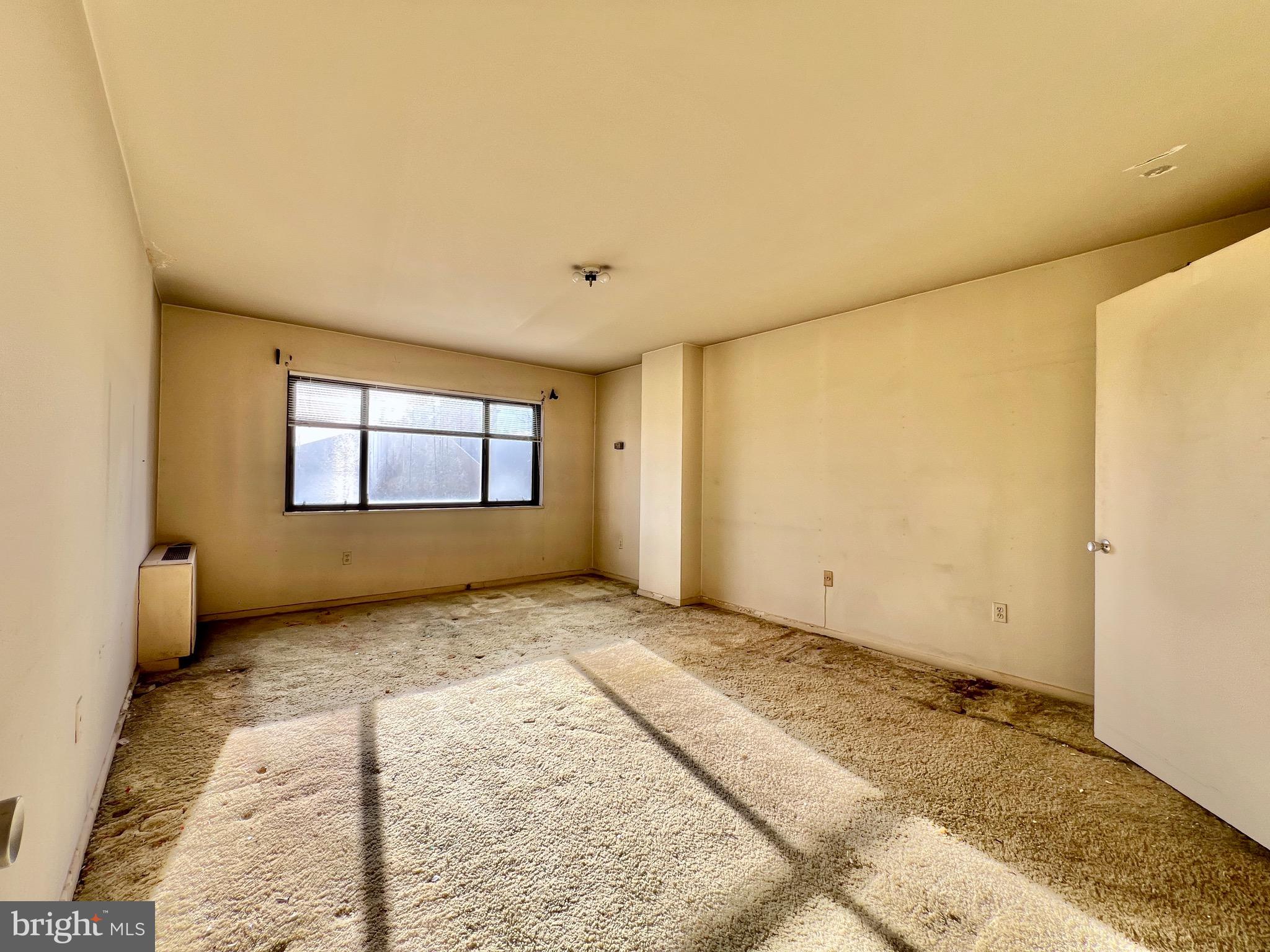 8830 Piney Branch Road, Unit 402 Silver Spring, MD 20903 - Photo 10 of 23 a view of an empty room and window