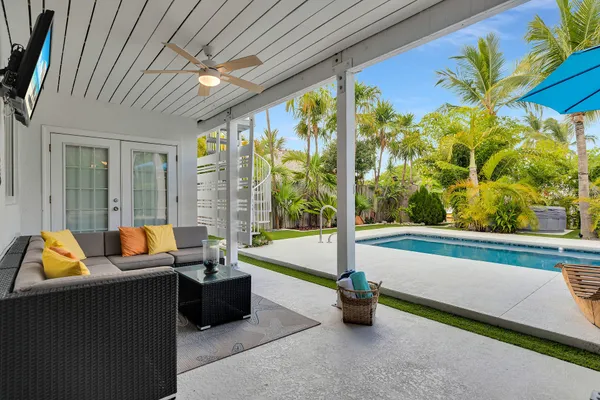 a kitchen with stainless steel appliances kitchen island granite countertop a sink and a refrigerator