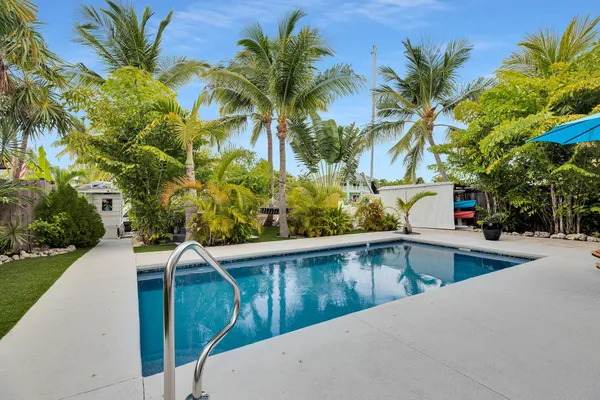 a kitchen with a refrigerator and a stove top oven