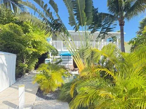 a view of a patio with a table and chairs under an umbrella