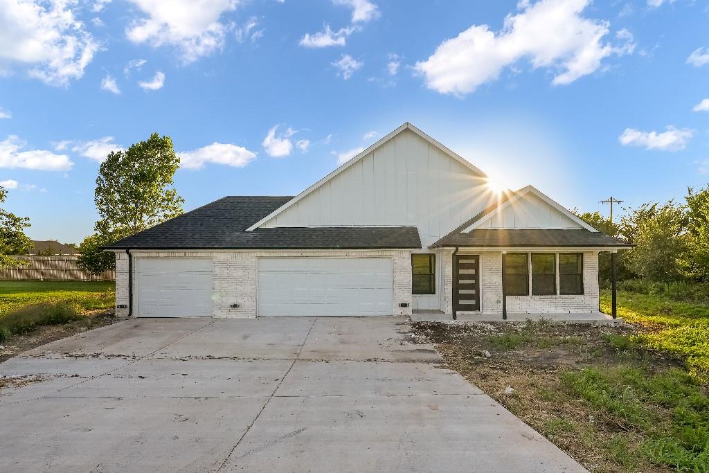 a view of a house with a yard and garage