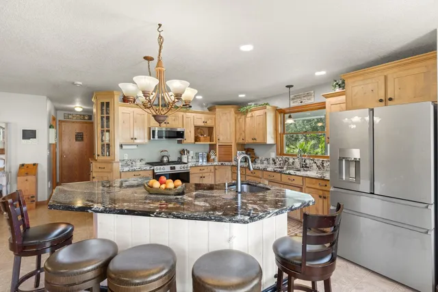 a bedroom with a bed and a chandelier
