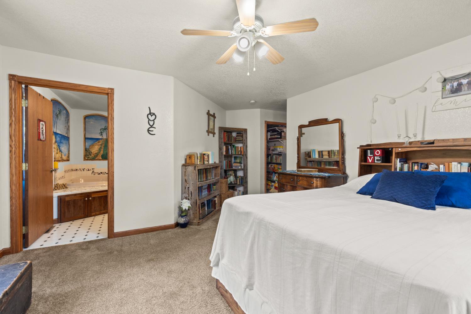 45 Lighthouse Lane Bangor, CA 95901 - Photo 17 of 63 a bedroom with a large bed and a chandelier