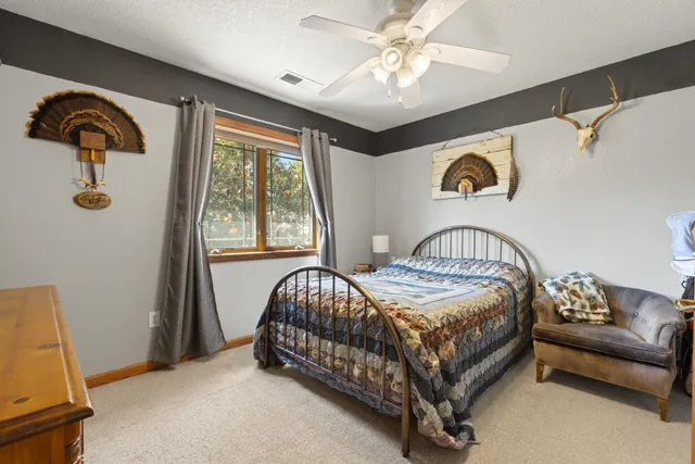 a bedroom with a bed couch and window