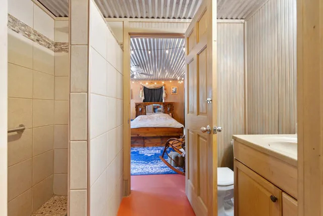 a kitchen with refrigerator and cabinets