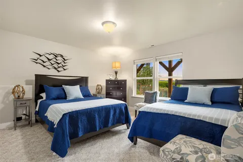 a bedroom with a large bed and a window