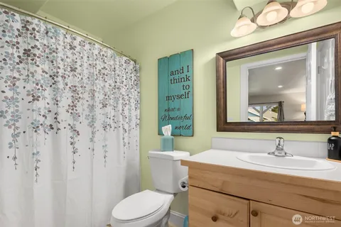 a bathroom with a sink mirror vanity and toilet