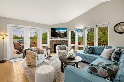 a living room with furniture fireplace and a large window