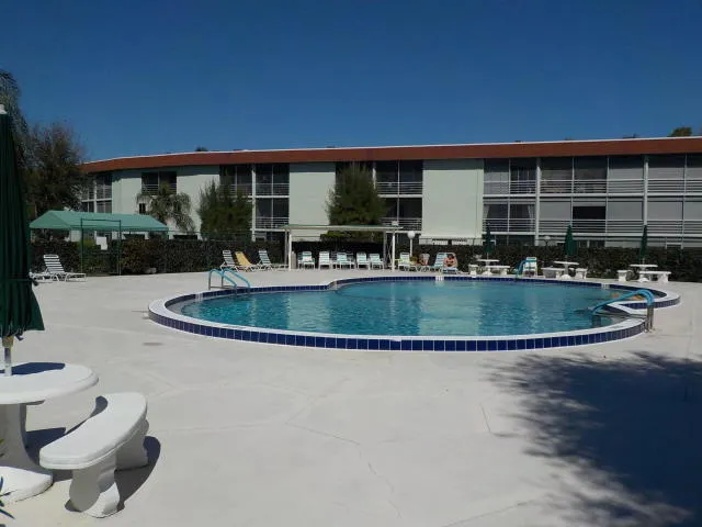 a view of a house with swimming pool and porch with furniture