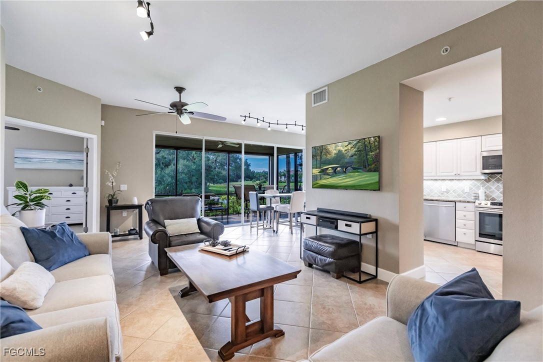 13120 Pebblebrook Point Circle, Unit 102 Fort Myers, FL 33905 - Photo 11 of 50 a living room with furniture and a flat screen tv