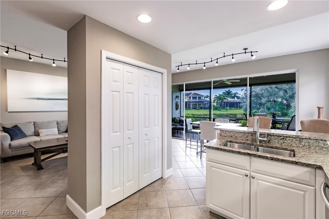 13120 Pebblebrook Point Circle, Unit 102 Fort Myers, FL 33905 - Photo 19 of 50 a kitchen with granite countertop a sink and a refrigerator