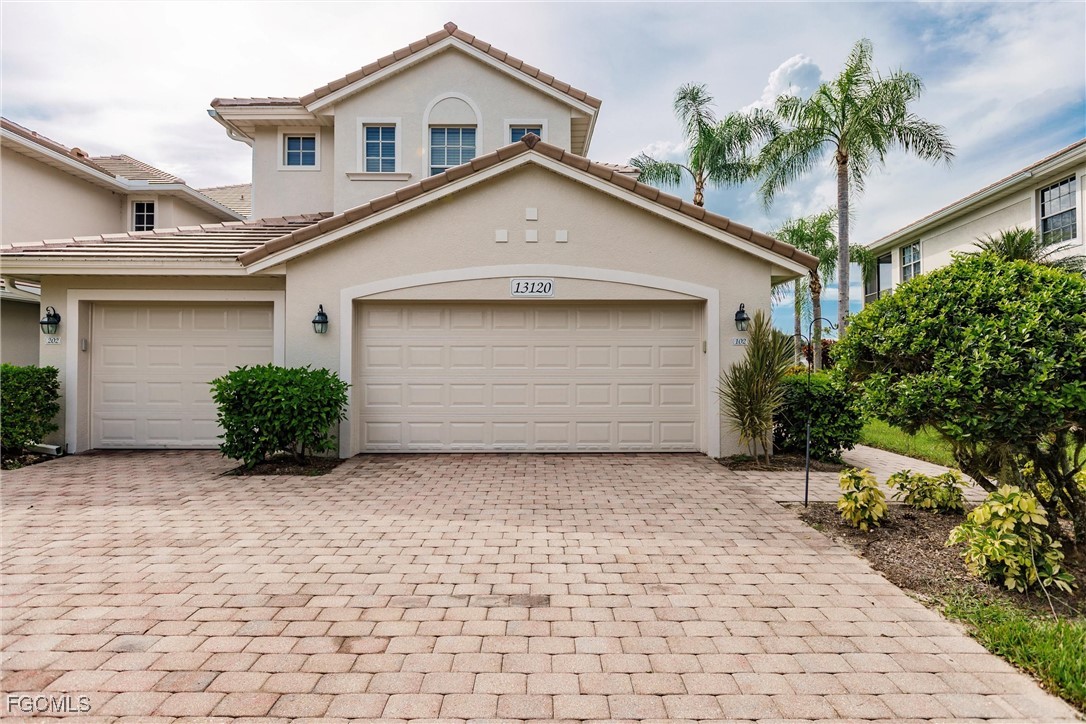 13120 Pebblebrook Point Circle, Unit 102 Fort Myers, FL 33905 - Photo 2 of 50 a view of a house with a small yard and plants