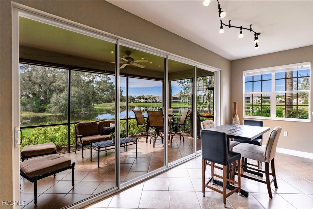 13120 Pebblebrook Point Circle, Unit 102 Fort Myers, FL 33905 - Photo 21 of 50 a dining room with furniture water view and a floor to ceiling window