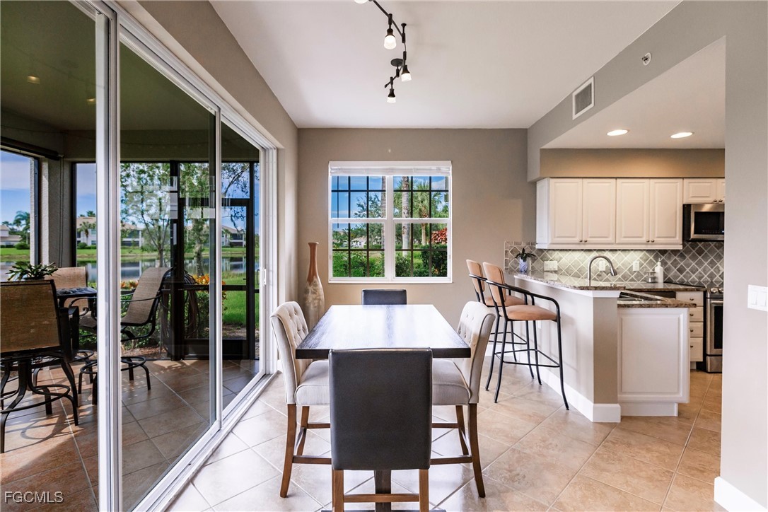 13120 Pebblebrook Point Circle, Unit 102 Fort Myers, FL 33905 - Photo 22 of 50 a large kitchen with a table and chairs in it