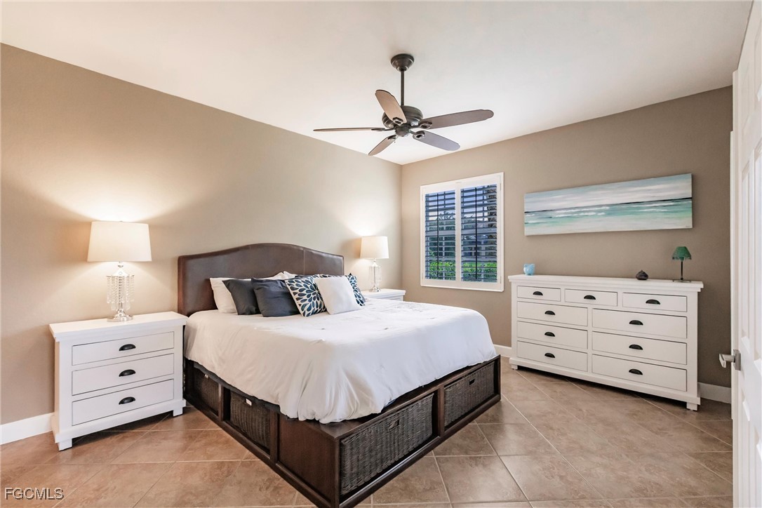13120 Pebblebrook Point Circle, Unit 102 Fort Myers, FL 33905 - Photo 24 of 50 a bedroom with a bed and a dresser