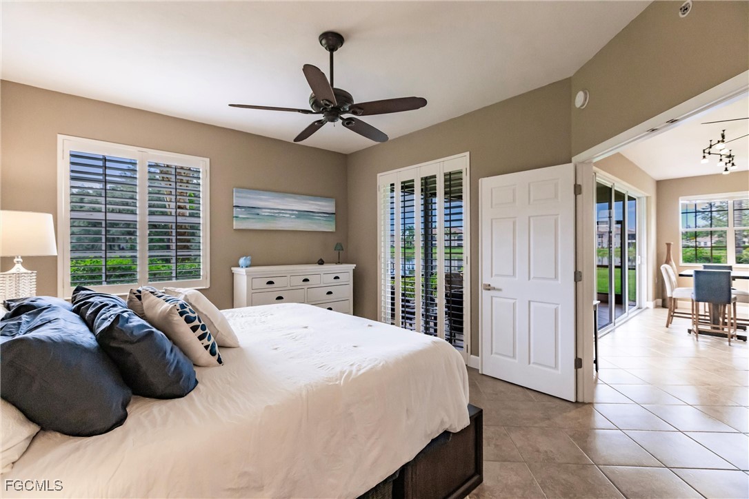 13120 Pebblebrook Point Circle, Unit 102 Fort Myers, FL 33905 - Photo 25 of 50 a bedroom with a bed a window and a chandelier