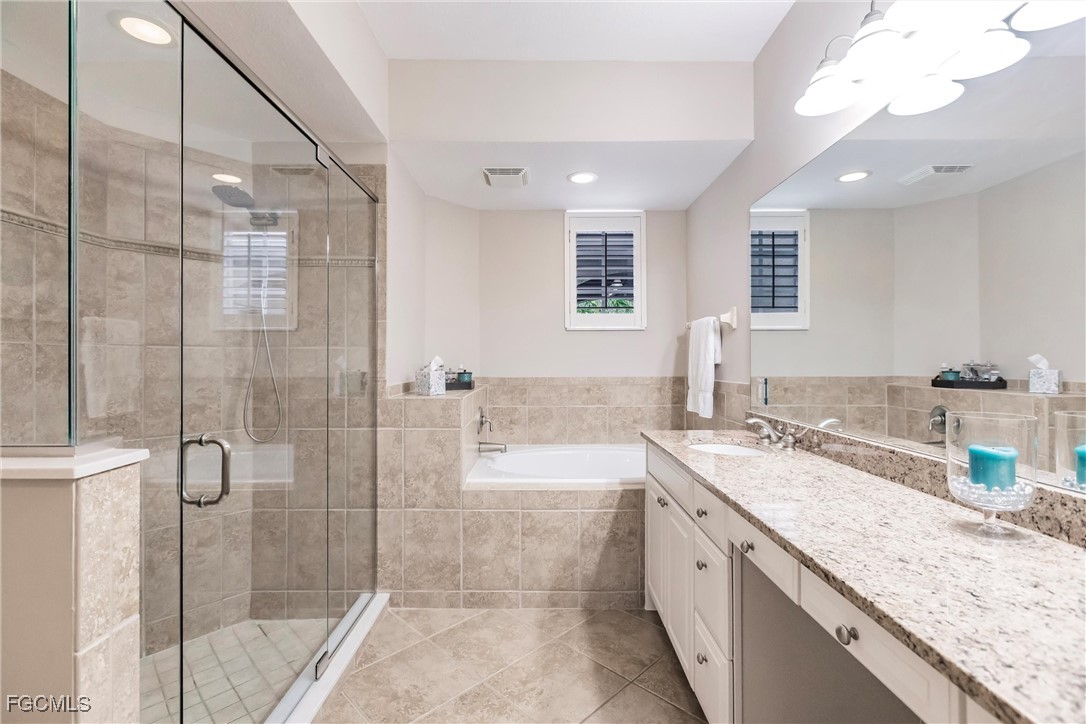 13120 Pebblebrook Point Circle, Unit 102 Fort Myers, FL 33905 - Photo 31 of 50 a large bathroom with a granite countertop sink a mirror and a shower
