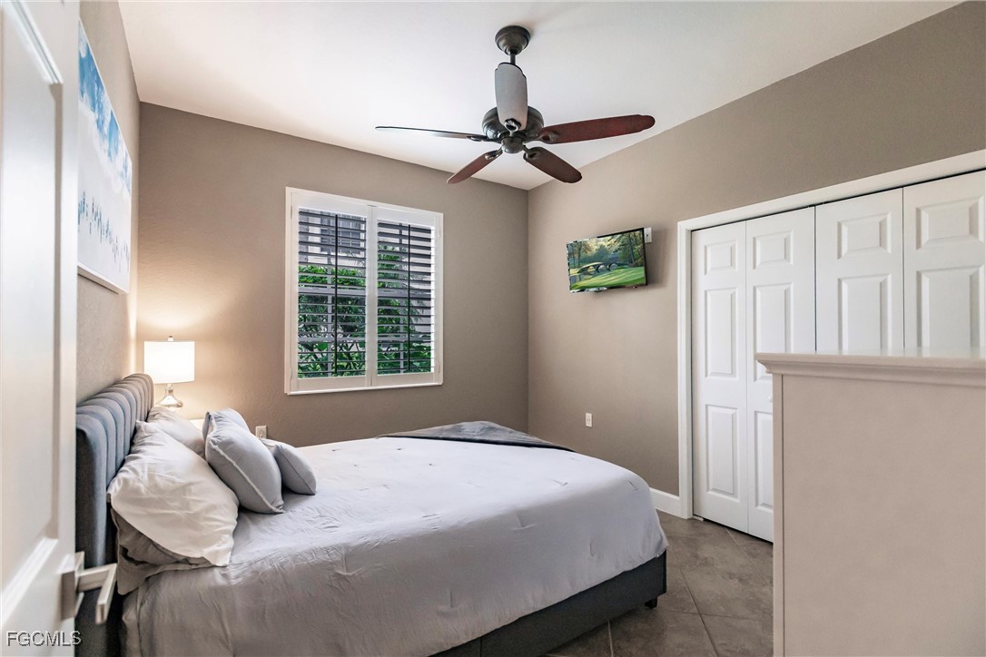 13120 Pebblebrook Point Circle, Unit 102 Fort Myers, FL 33905 - Photo 33 of 50 a bedroom with a bed dresser and a window