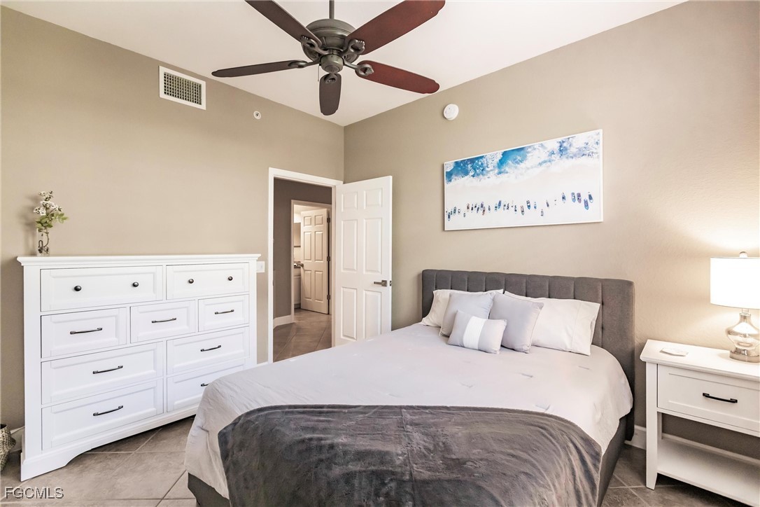 13120 Pebblebrook Point Circle, Unit 102 Fort Myers, FL 33905 - Photo 34 of 50 a bedroom with a bed and a cabinets