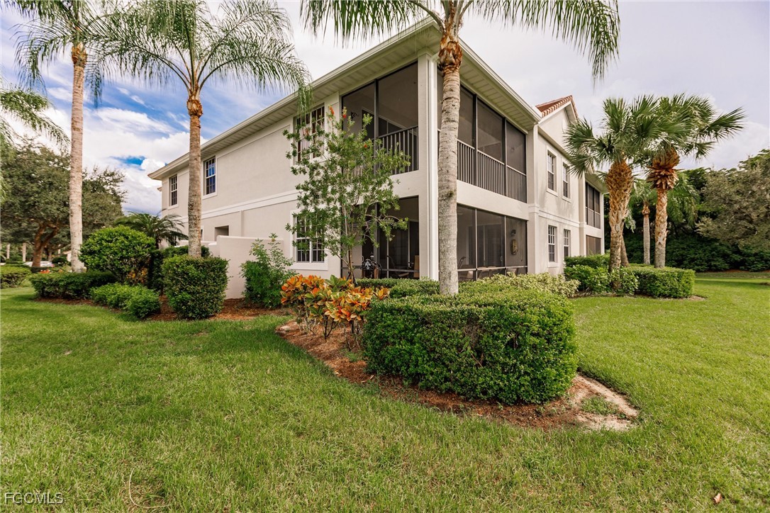 13120 Pebblebrook Point Circle, Unit 102 Fort Myers, FL 33905 - Photo 41 of 50 a front view of a house with a yard
