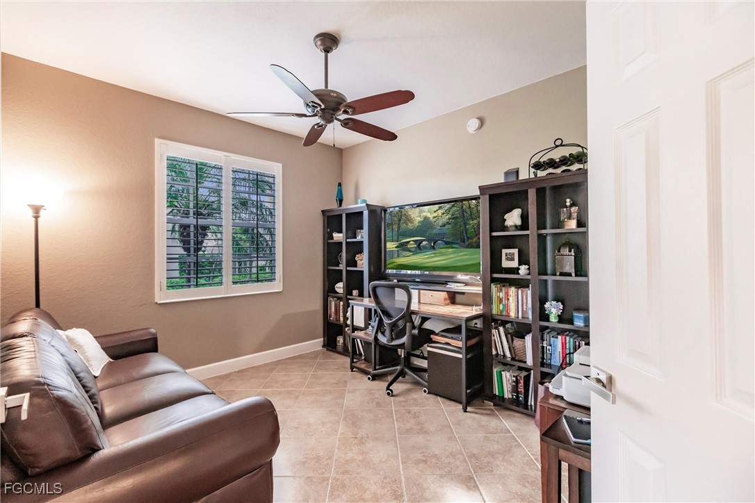 13120 Pebblebrook Point Circle, Unit 102 Fort Myers, FL 33905 - Photo 6 of 50 a living room with furniture a window and a flat screen tv