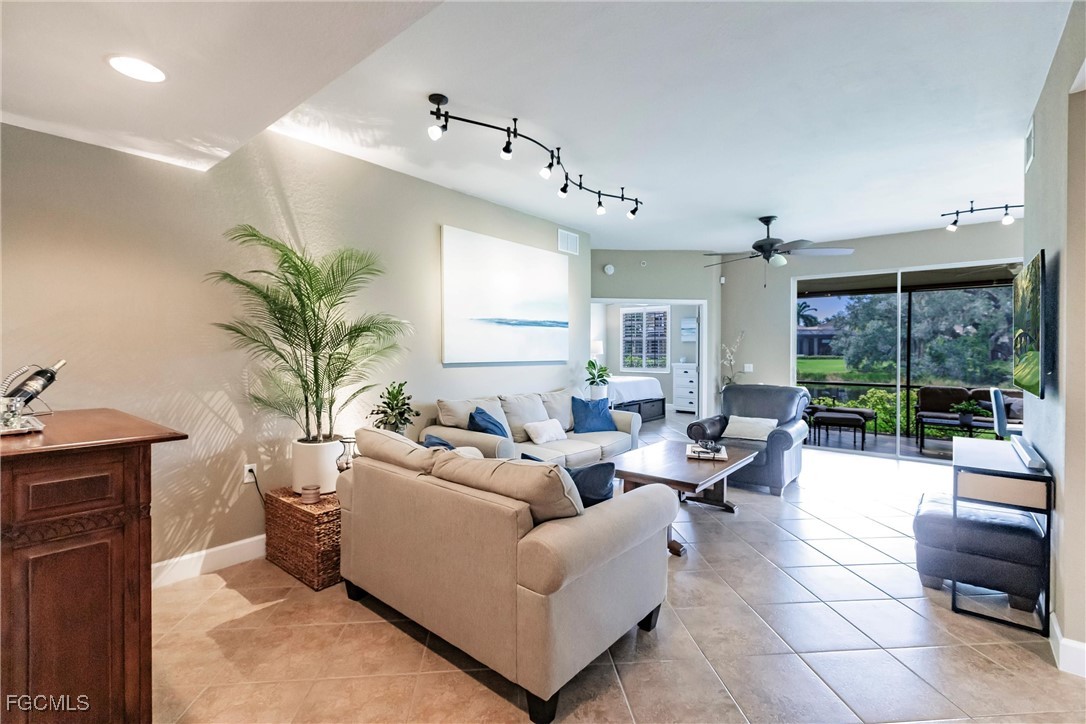 13120 Pebblebrook Point Circle, Unit 102 Fort Myers, FL 33905 - Photo 9 of 50 a living room with furniture potted plant and a large window