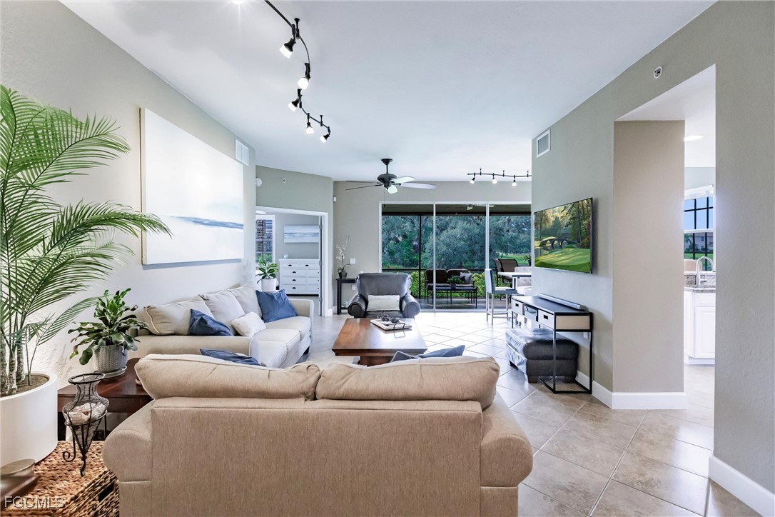 13120 Pebblebrook Point Circle, Unit 102 Fort Myers, FL 33905 - Photo 10 of 50 a living room with furniture and a flat screen tv