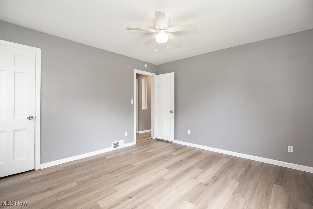 1547 Genesee Road South Euclid, OH 44121 - Photo 15 of 36 Unfurnished room featuring a ceiling fan, light wood-style flooring, and baseboards