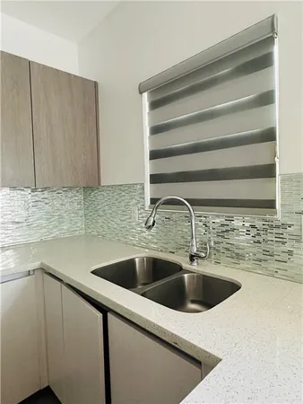 a kitchen with a sink and cabinets