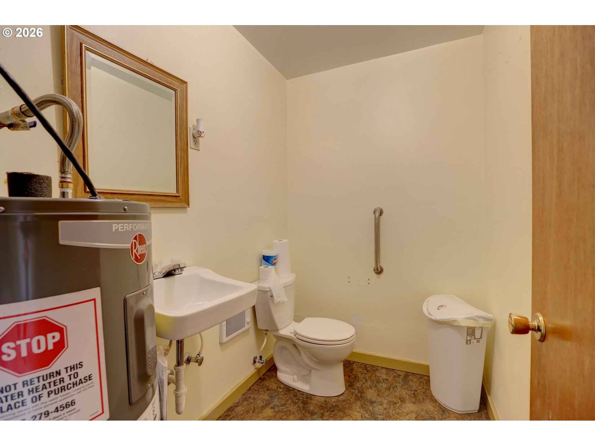1013 Clark Street Wasco, OR 97065 - Photo 8 of 19 a bathroom with a toilet a sink and mirror