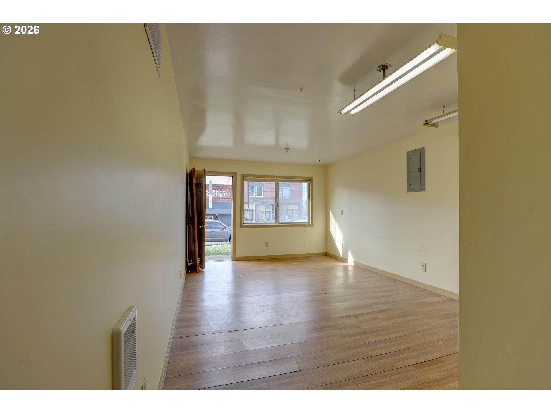 1013 Clark Street Wasco, OR 97065 - Photo 9 of 19 a view of an empty room with a window and wooden floor