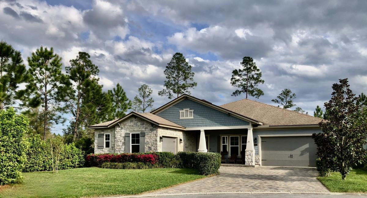 90 Nyes Place St. Augustine, FL 32092 - Photo 1 of 32 a front view of a house with a garden
