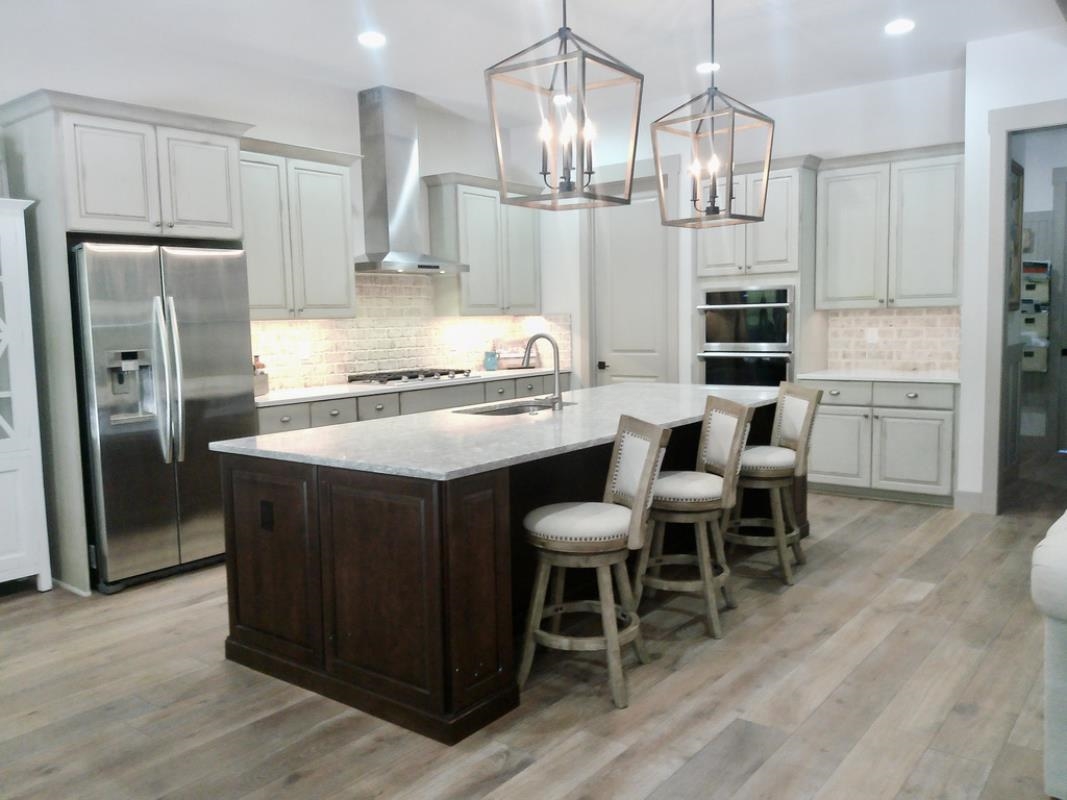 90 Nyes Place St. Augustine, FL 32092 - Photo 4 of 32 a kitchen with stainless steel appliances granite countertop a table chairs stove and refrigerator