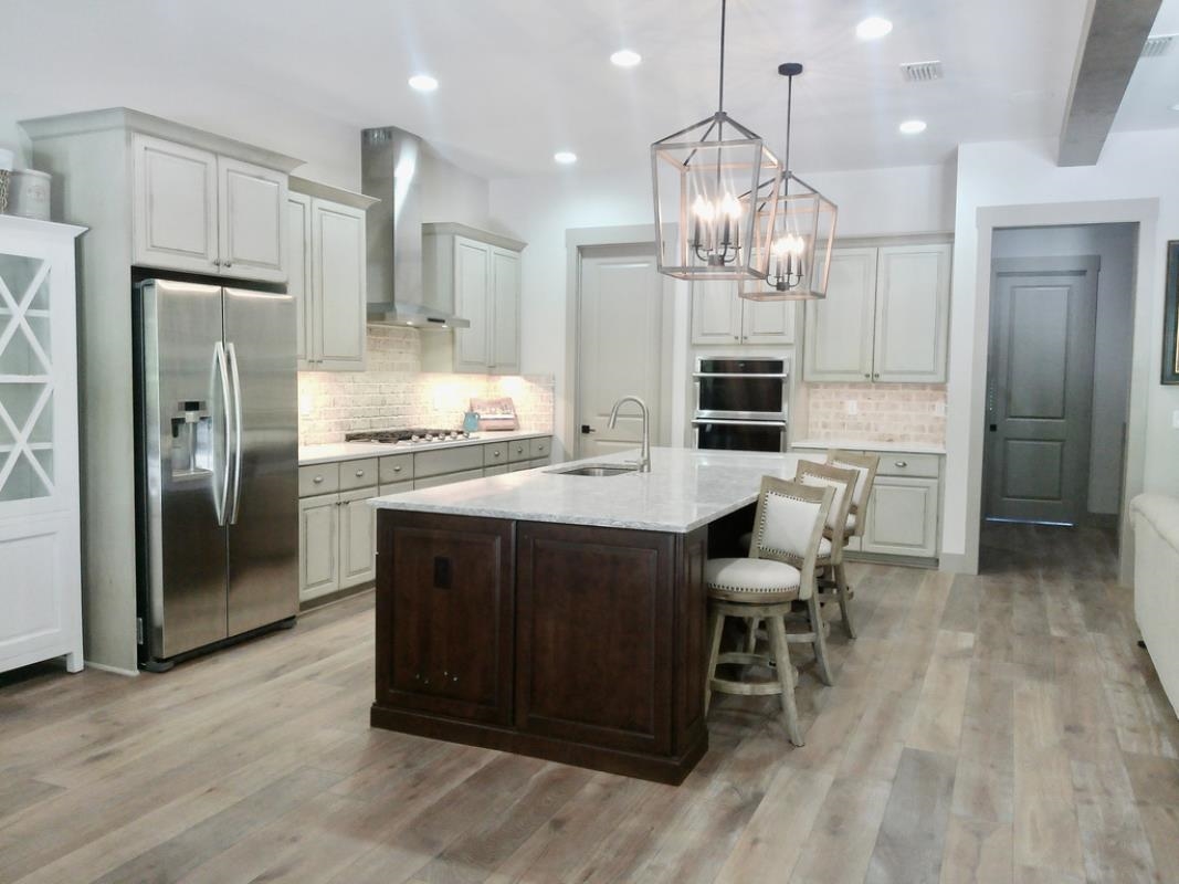 90 Nyes Place St. Augustine, FL 32092 - Photo 5 of 32 a kitchen with stainless steel appliances kitchen island granite countertop a refrigerator and a stove top oven