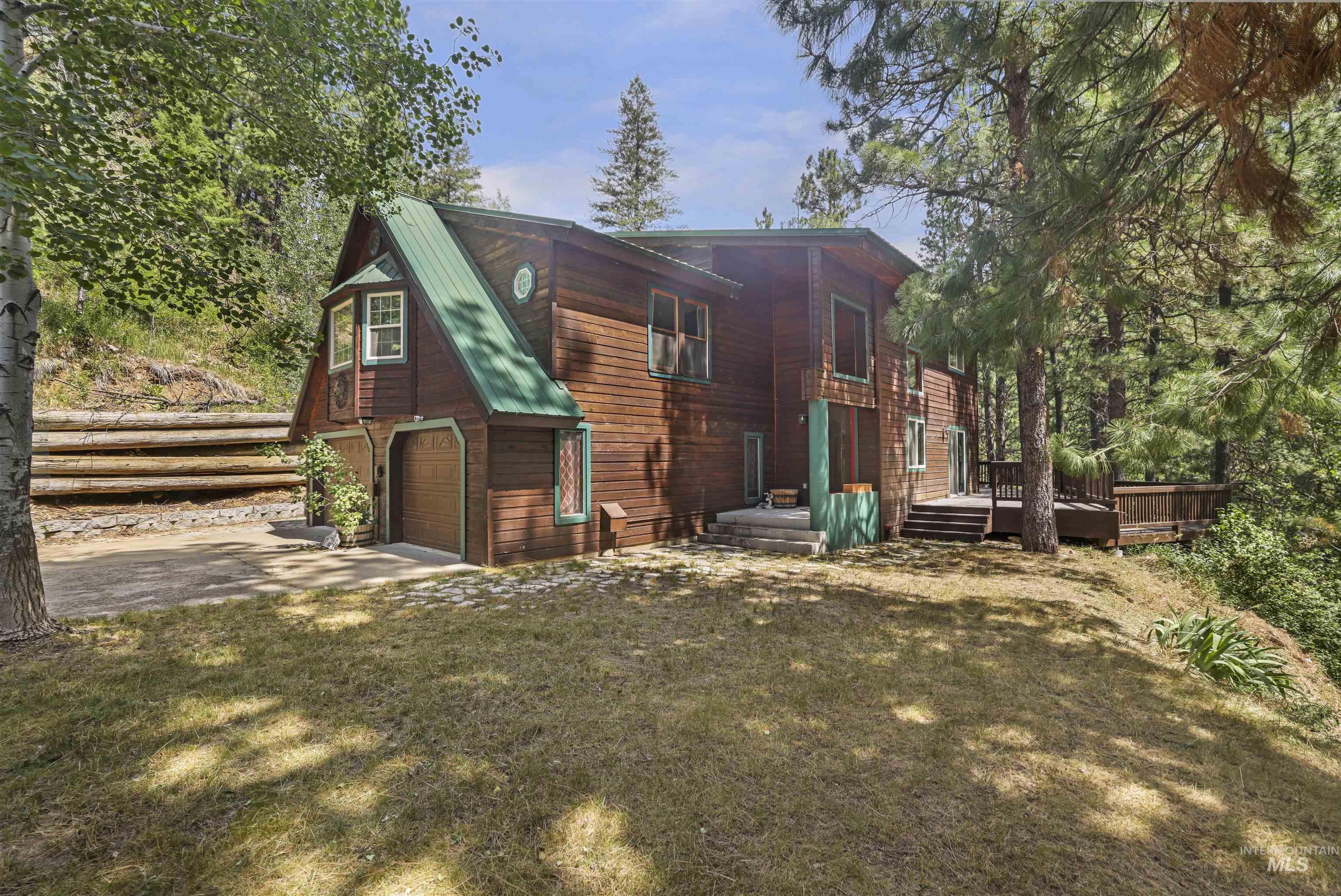 224 Dakota Road Mountain Home, ID 83647 - Photo 39 of 50 Wood-sided residence featuring a green metal roof and an attached garage
