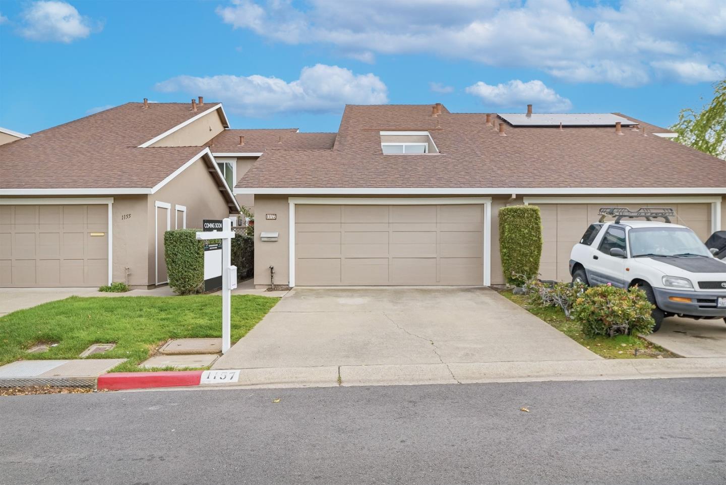 a front view of a house with a yard and garage