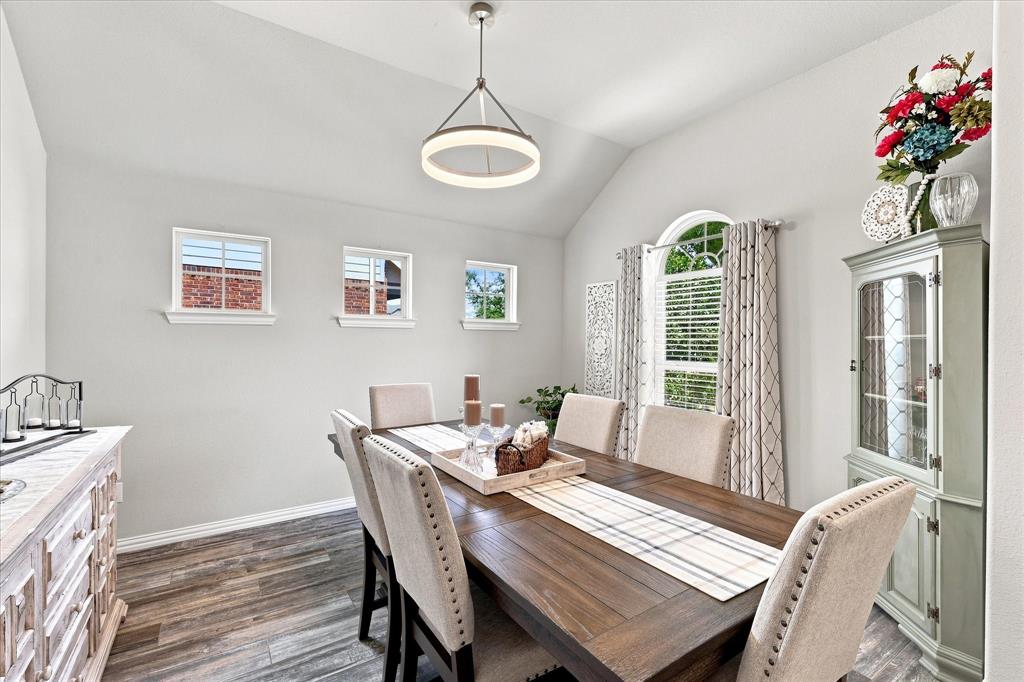 15729 Preble Road Fort Worth, TX 76177 - Photo 8 of 37 Formal Dining Room features a Vaulted Ceiling, Contemporary Designer Lighting, Upgraded Wood-look Tile Flooring and Abundant Natural Light. The Open Design and Architectural Details create an Impressive Space for Entertaining.