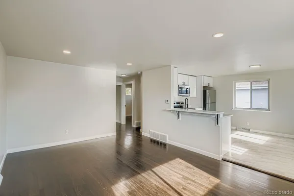 a view of a kitchen with a sink and a refrigerator