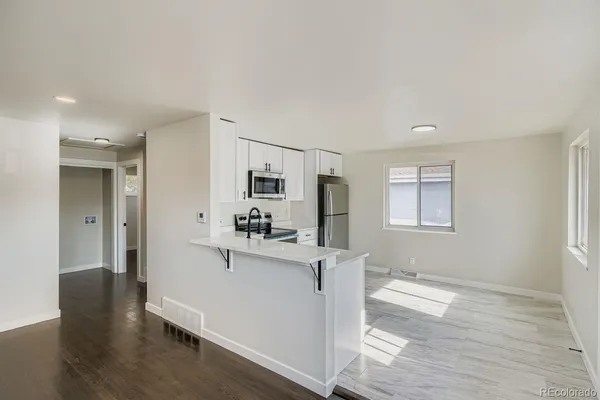 a kitchen with stainless steel appliances a refrigerator and a stove top oven