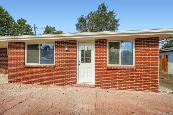 a view of a brick house with large windows