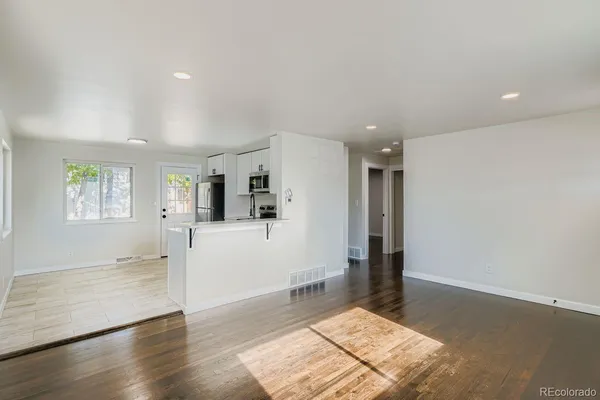 a view of livingroom with hardwood floor and a hallway