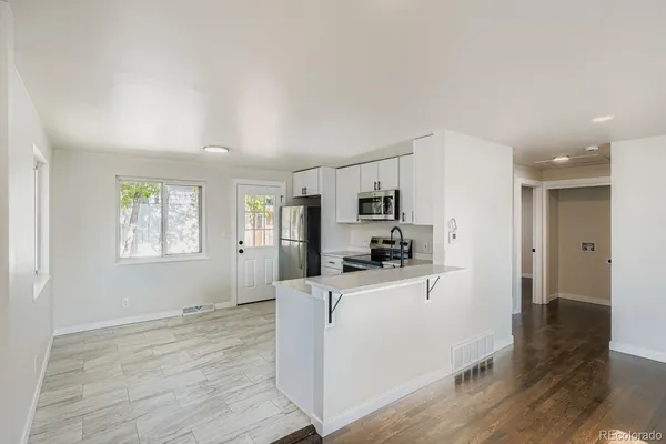 a kitchen with stainless steel appliances a refrigerator and a stove top oven