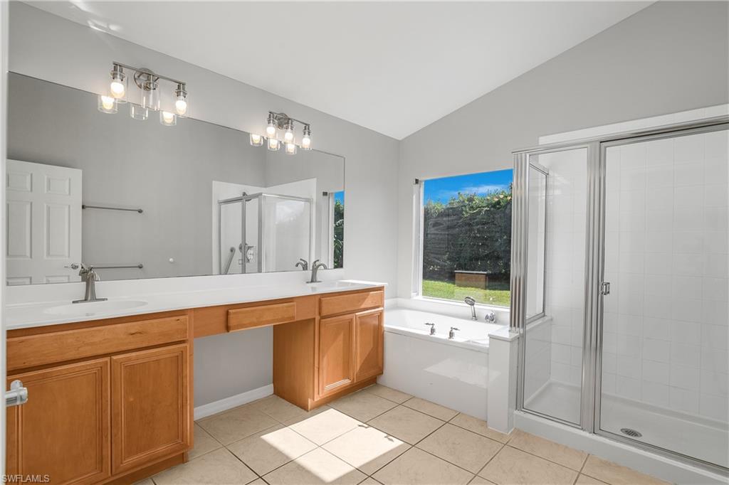 2022 Fairmont Lane Naples, FL 34120 - Photo 11 of 33 a large white kitchen with a large window and refrigerator