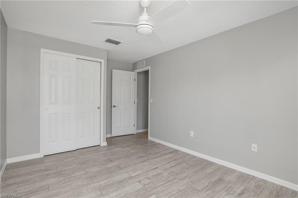 2022 Fairmont Lane Naples, FL 34120 - Photo 14 of 33 a view of an empty room with wooden floor