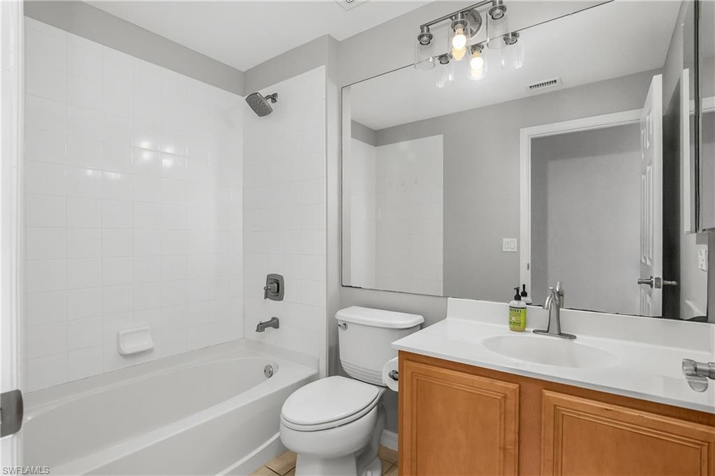 2022 Fairmont Lane Naples, FL 34120 - Photo 16 of 33 a bathroom with a granite countertop sink a toilet and shower