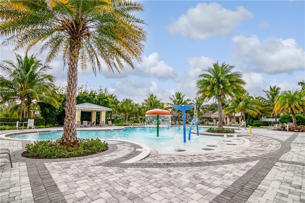 2022 Fairmont Lane Naples, FL 34120 - Photo 24 of 33 a view of a swimming pool with a table and chairs