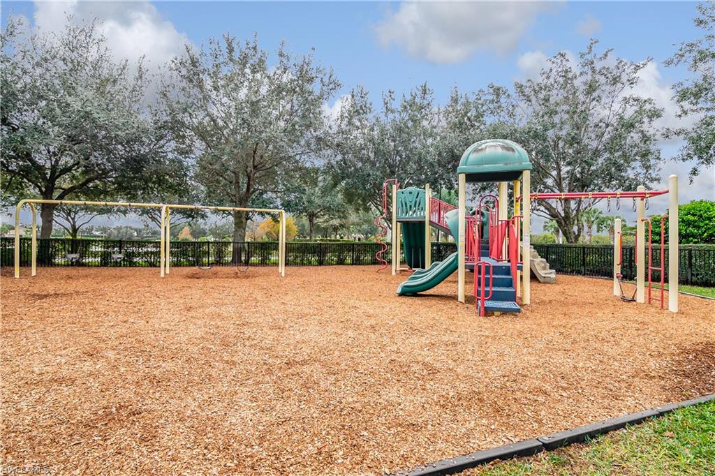 2022 Fairmont Lane Naples, FL 34120 - Photo 26 of 33 a view of outdoor space with playground and green space