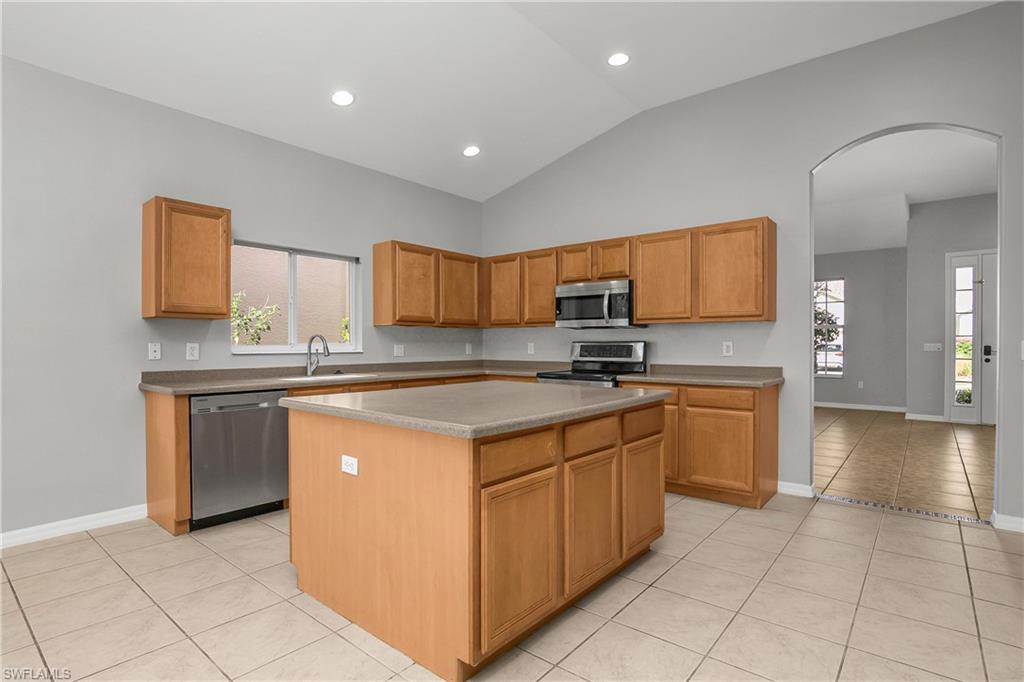 2022 Fairmont Lane Naples, FL 34120 - Photo 5 of 33 a kitchen with stainless steel appliances granite countertop a sink and a stove